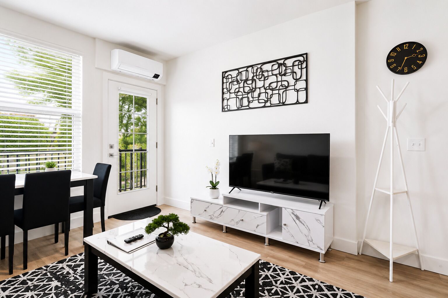 A modern living room with a TV, a dining area with chairs, a white console table, and a floor lamp.