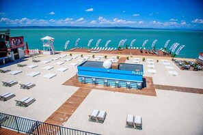 A beachside resort with a pool area, sun loungers, and a lifeguard tower. - Holiday apartment with modern furnishings and air conditioning, close to the centre and the beach (Siófok)