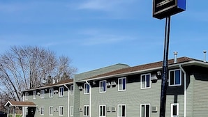 A two-story building with a sign for EconoLux Inn.