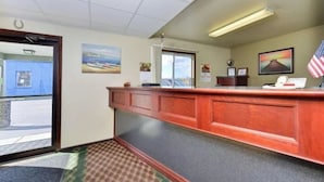 An office with a reception desk, a door, and a window.