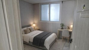 A bedroom with a bed, bedside tables, a desk, and a window. - Bright & Quiet Easily access to seoul– Monthly Stay (30+ Nights) (Yangju-si)