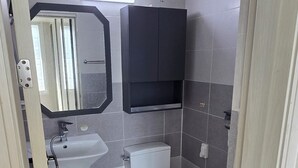 A modern bathroom with a toilet, sink, and mirror. - Bright & Quiet Easily access to seoul– Monthly Stay (30+ Nights) (Yangju-si)