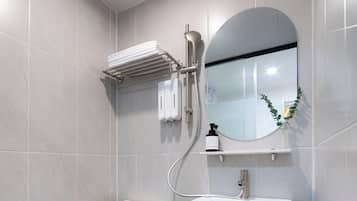 A modern bathroom with a toilet, sink, and shower.
