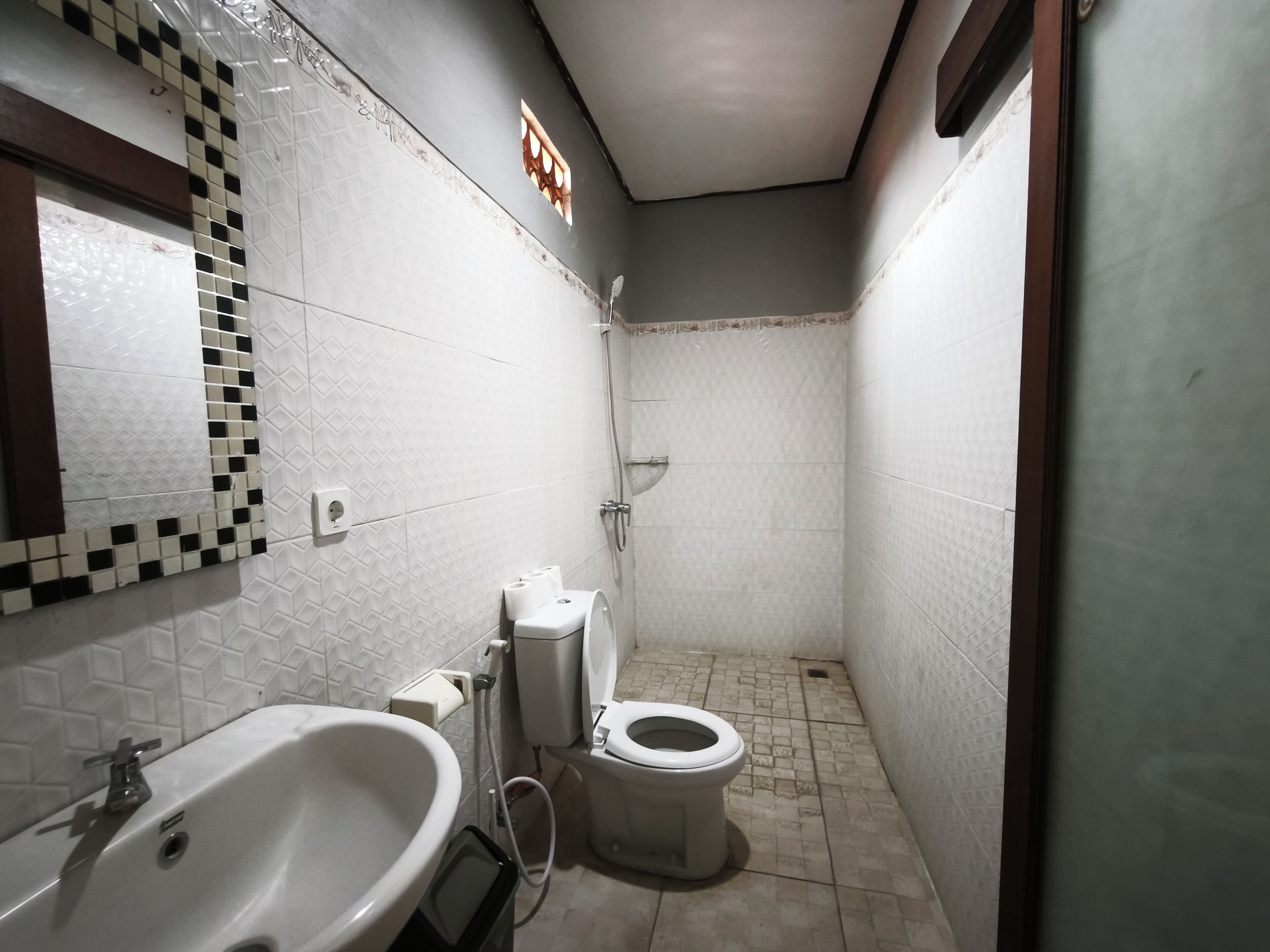 A bathroom with a sink, toilet, and shower.