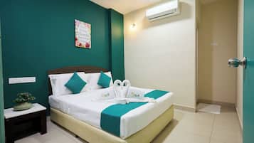 A hotel room with a bed, a nightstand, a wall-mounted air conditioner, and a door.