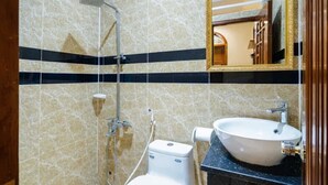 A bathroom with a toilet, sink, and shower. - Collection O Long Phung Hotel (Ho Chi Minh City)