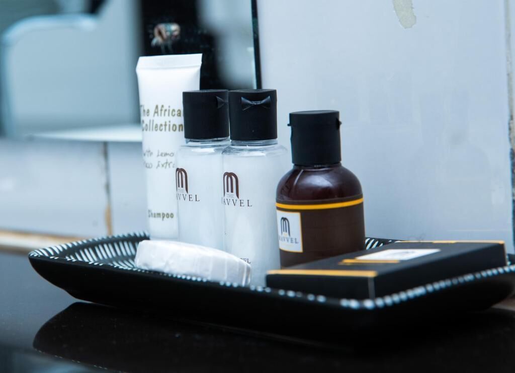 A tray with toiletries including a shampoo bottle, a conditioner bottle, and a bottle of lotion.