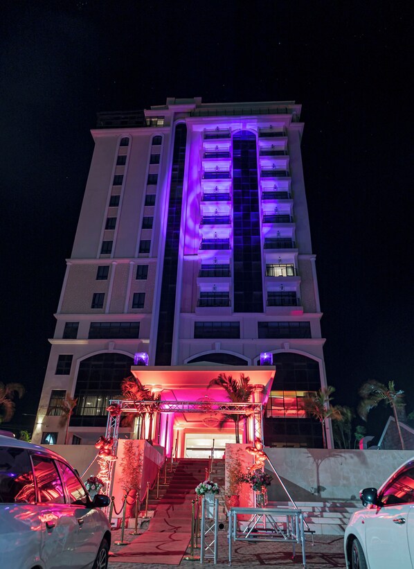 A multi-story hotel with a prominent vertical light display on the facade. - THE MAVVEL (Mutunduri)