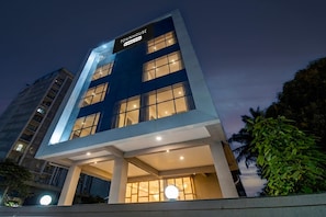 A modern building with a sign reading 'TOWNHOUSE' and a balcony area. - POP 84260d Hotel City Centre (Pune)