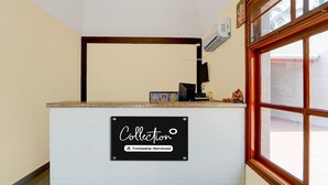 A reception desk with a sign reading 'Collection Company-Serviced.' - Classic Hotel Phoenix (Valappadi)