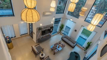 Deluxe Villa, Balcony, Garden View | Living area | 55-inch flat-screen TV with satellite channels