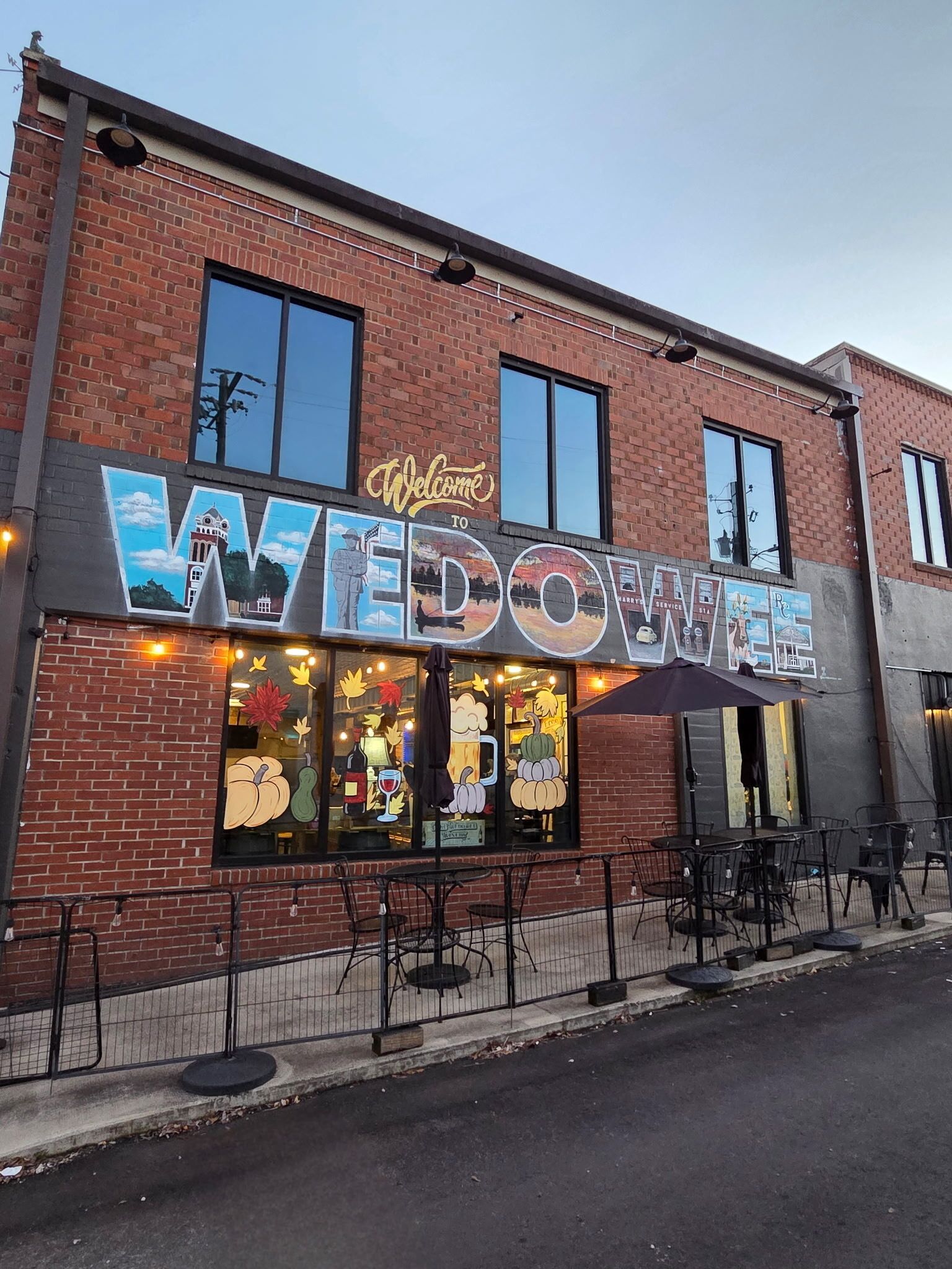 A brick building with a large sign reading 'Welcome to WEDOWIA.'
