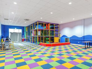 A play area with a colorful checkered floor, a play structure, and seating. - 5T Monk's Rock - UKC8995 (Illfracombe)