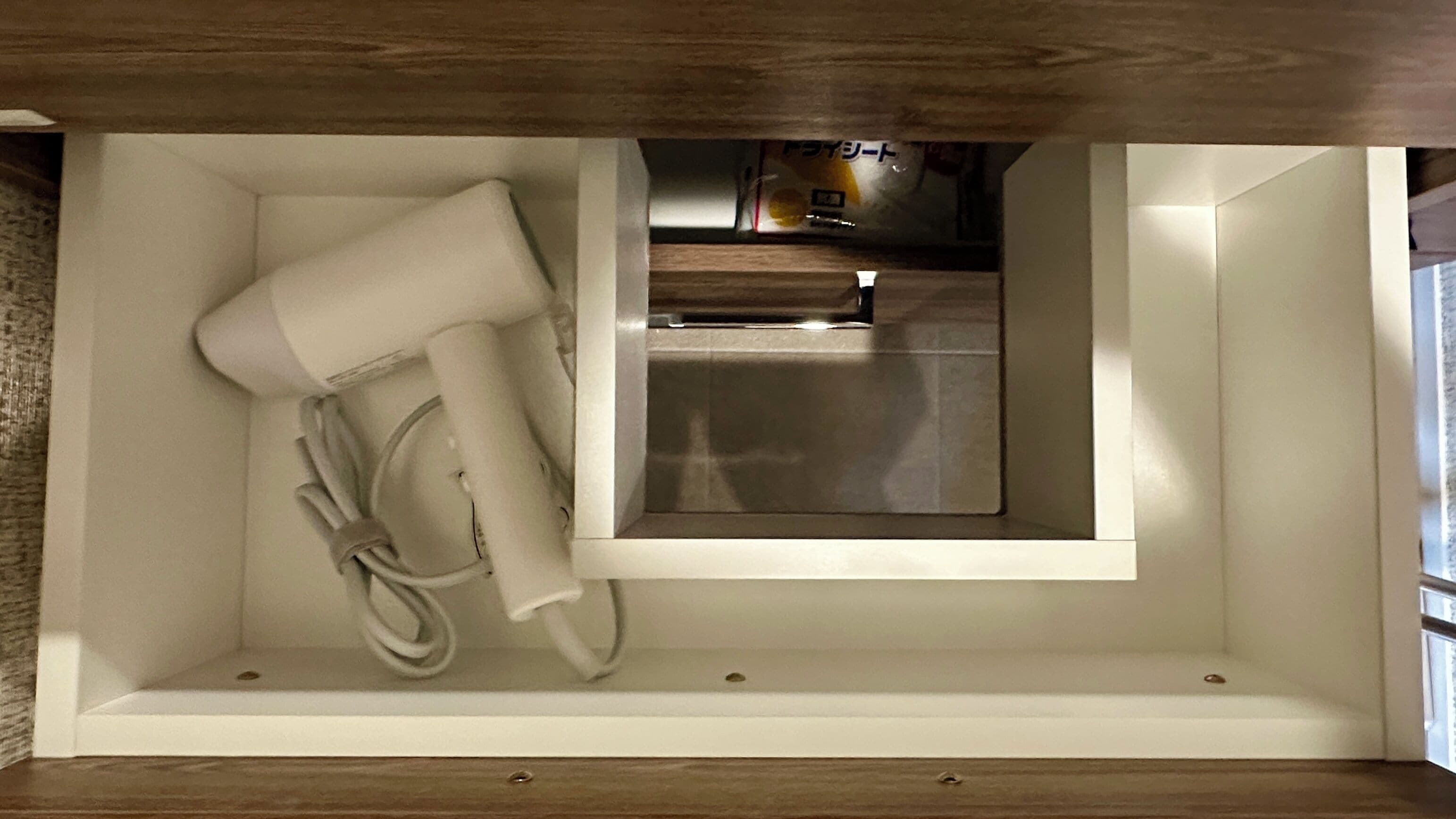 A kitchen with a built-in oven and a small window.