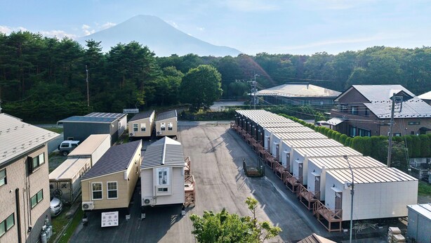 A large industrial area with multiple buildings, including a warehouse and a facility with a long row of portable cabins. - Solana Smart INN Fuji Yamanakako (Yamanakako)