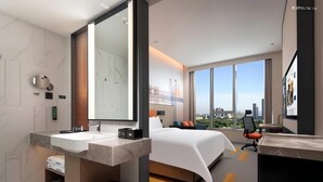 A modern hotel room with a large bed, a desk, and a view of the city. - Hampton by Hilton Hangzhou Xiaoshan Jiangnan Technology City. (Hangzhou)