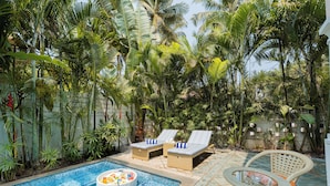 A pool area with lounge chairs and a small hot tub. - ELIVAAS Celest 4 BHK Villa with Pvt Pool (Arpora)
