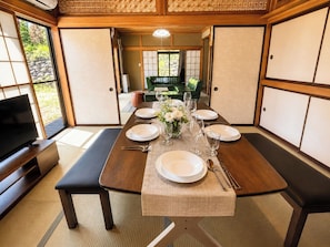 A traditional Japanese-style room with tatami flooring, a low table set for dining, and a television on a wooden stand. - Near the World Heritage Site Nikko Toshogu Shrine  7minute walk from Nikko Station  1minute from / Nikko City Tochigi (Nikko City)