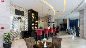 A modern lobby with a bar area, seating, and a staircase. - Comfortable room, 100m to walking st, 5th floor (Angeles)