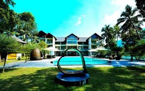 A resort with a swimming pool, outdoor seating, and a large building with multiple balconies. - Malankara palace lake view resort & spa (Thodupuzha)
