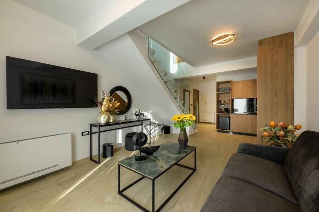 Junior Suite, Balcony | Living area | TV