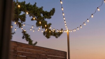 A string of lights draped over a wooden fence.
