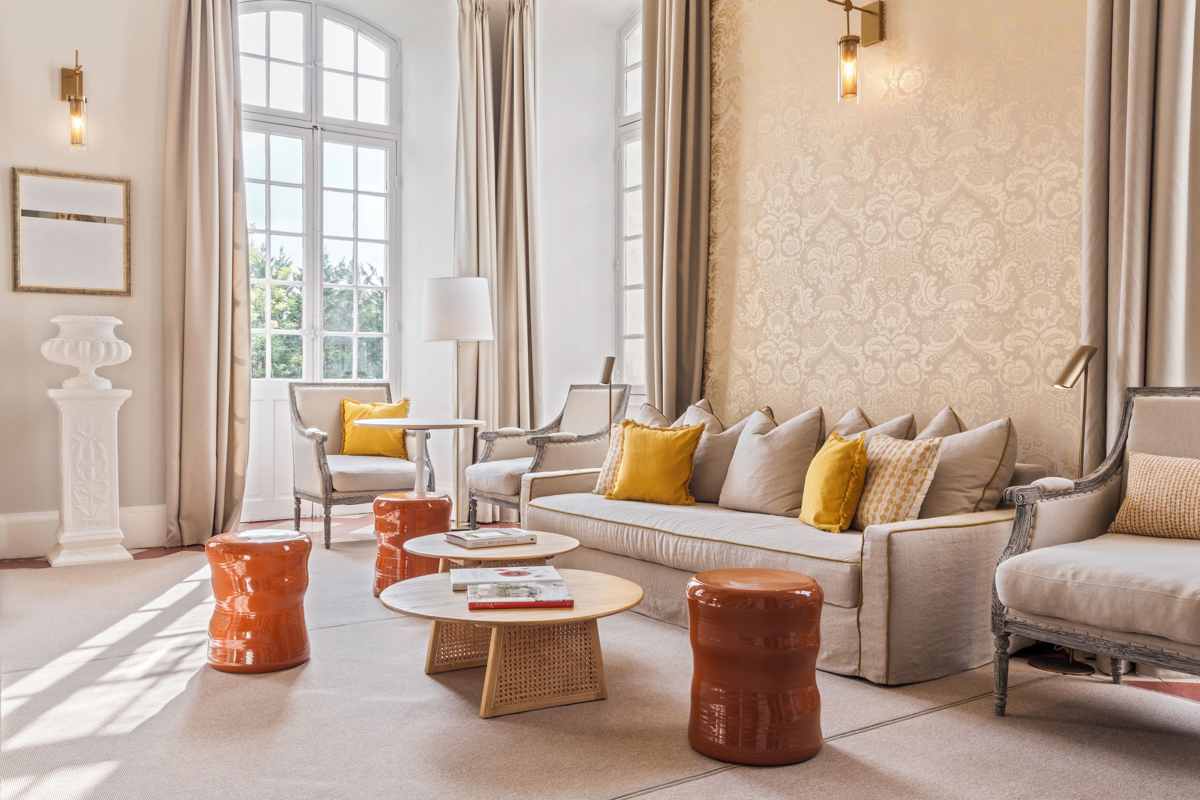 A spacious living room with a sofa, armchairs, and a coffee table.