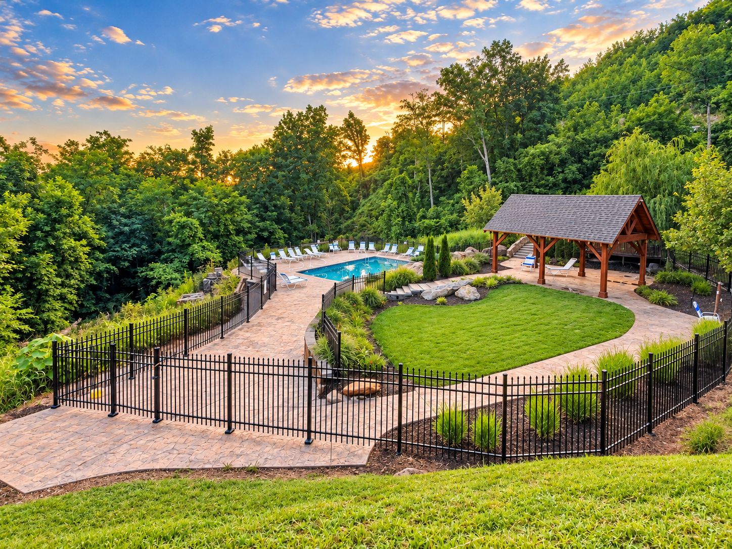 A backyard with a swimming pool, a wooden gazebo, and a fenced patio area.