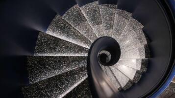 A spiral staircase with a terrazzo finish.