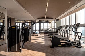 A gym with cardio machines, weight machines, and a herringbone-patterned floor. - Sofitel Changzhou Hi-tech District (Zhenjiang)