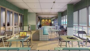 A modern cafe with a central bar, seating area, and large windows.
