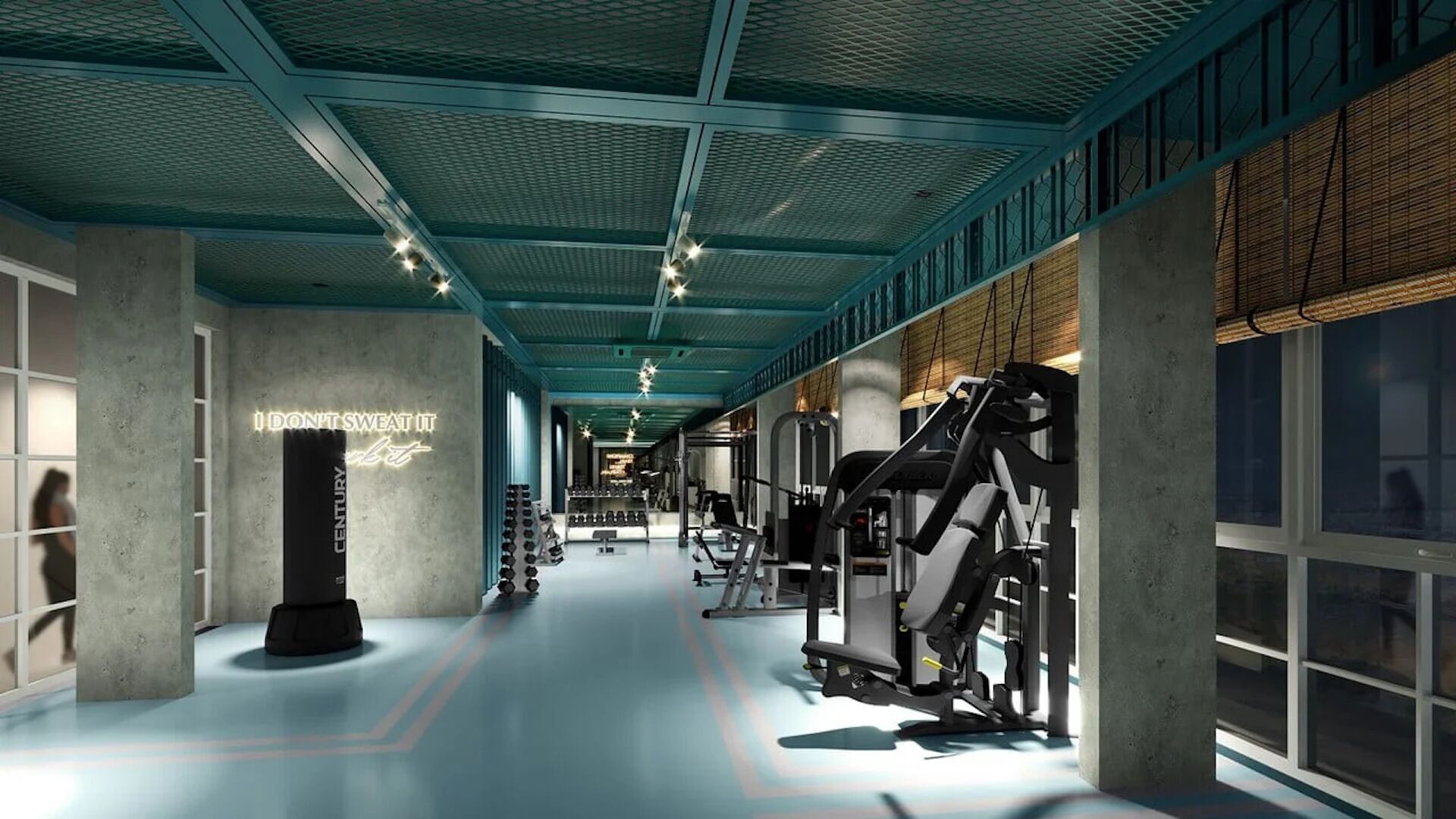 A gym with exercise equipment, a neon sign, and a concrete pillar.