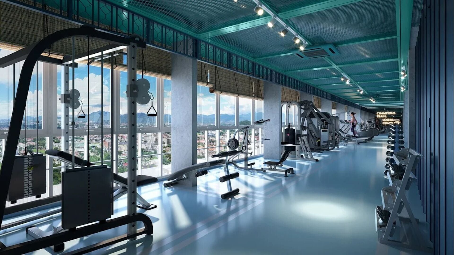 Une salle de sport équipée de divers appareils d’exercice, de grandes fenêtres offrant une vue sur la ville et un plafond haut avec un éclairage bleu.