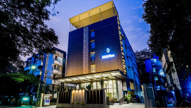 A multi-story hotel with a prominent 'Star Place' sign, a covered entrance, and a modern architectural design. - Hotel Star Place - Chennai (Chennai)
