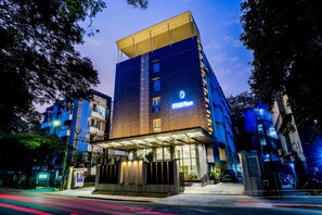A multi-story hotel with a prominent 'Star Place' sign, a covered entrance, and a modern architectural design. - Hotel Star Place - Chennai (Chennai)