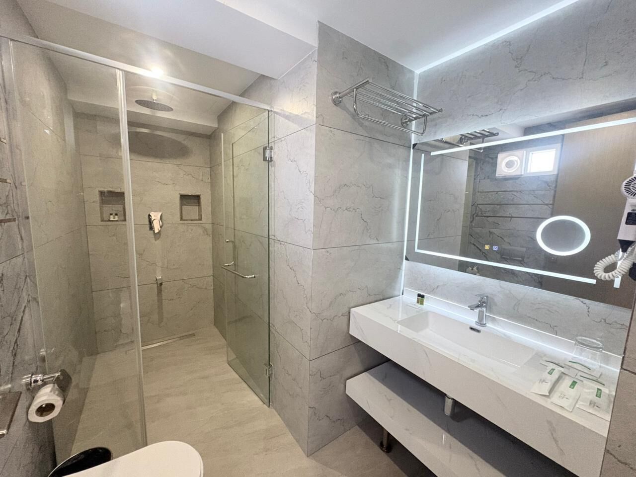 Shower, hair dryer, slippers, towels