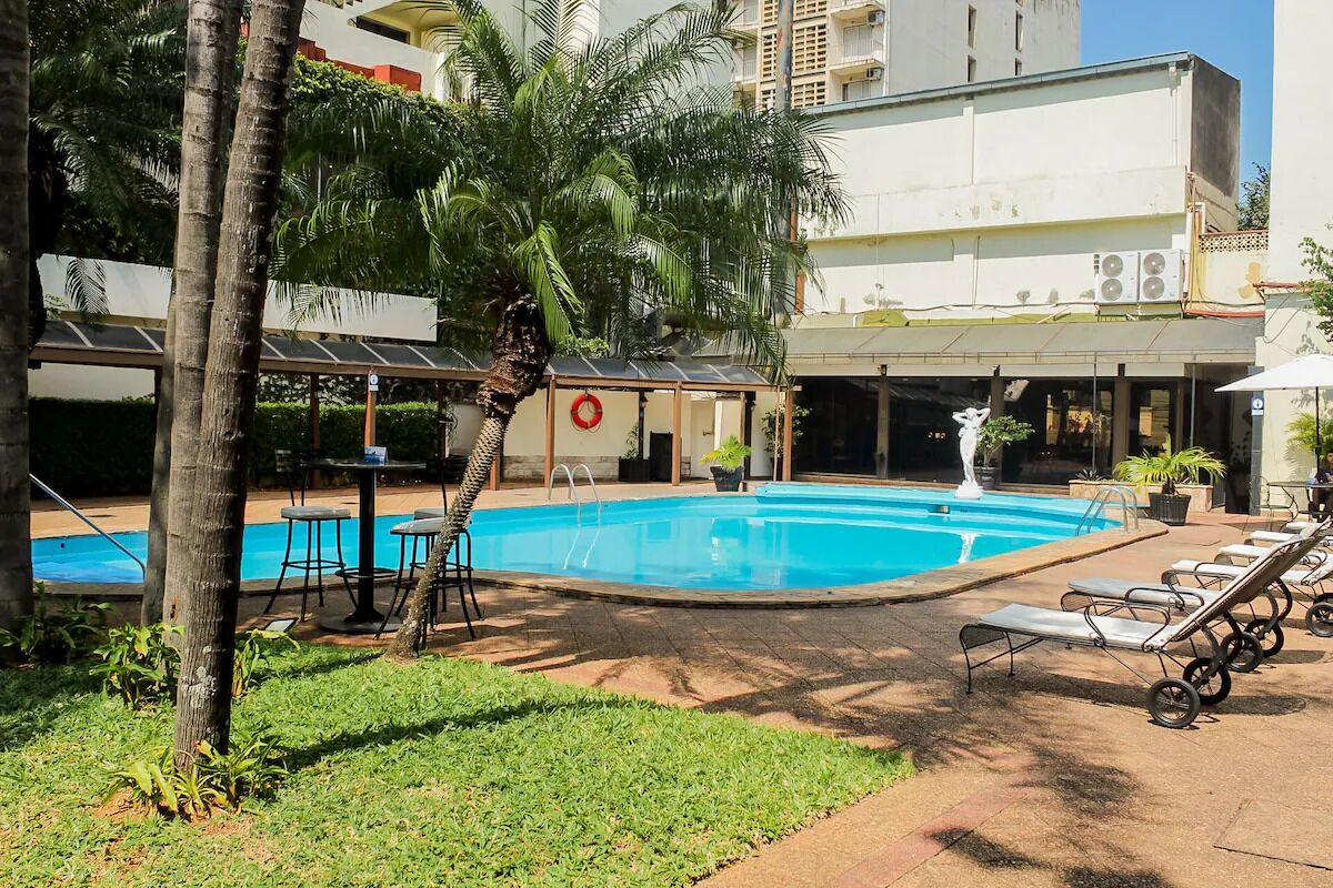 Serve and rally on the on-site court surrounded by palms.