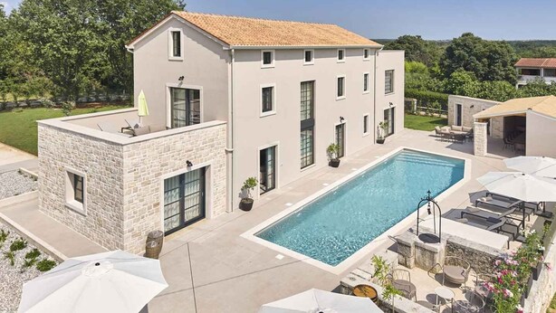 A two-story building with a swimming pool, outdoor seating, and a stone facade. - Villa with pool, only a few minutes from Poreč (Poreč)