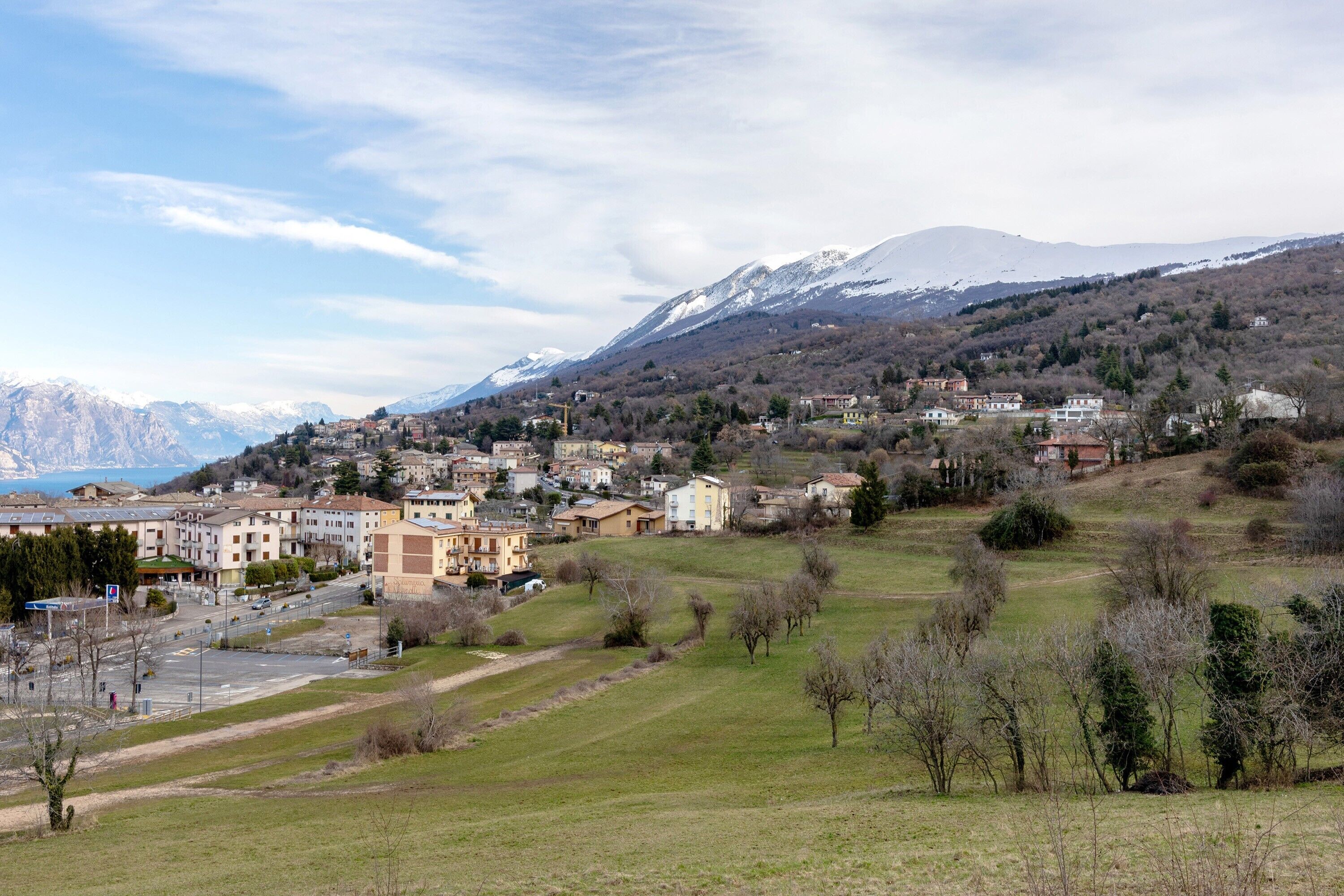 A town with buildings, a road, and a mountain in the background.