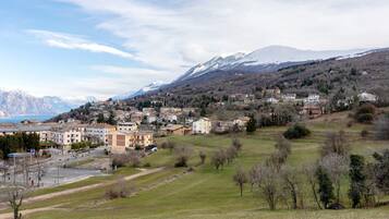 A town with buildings, a road, and a mountain in the background.