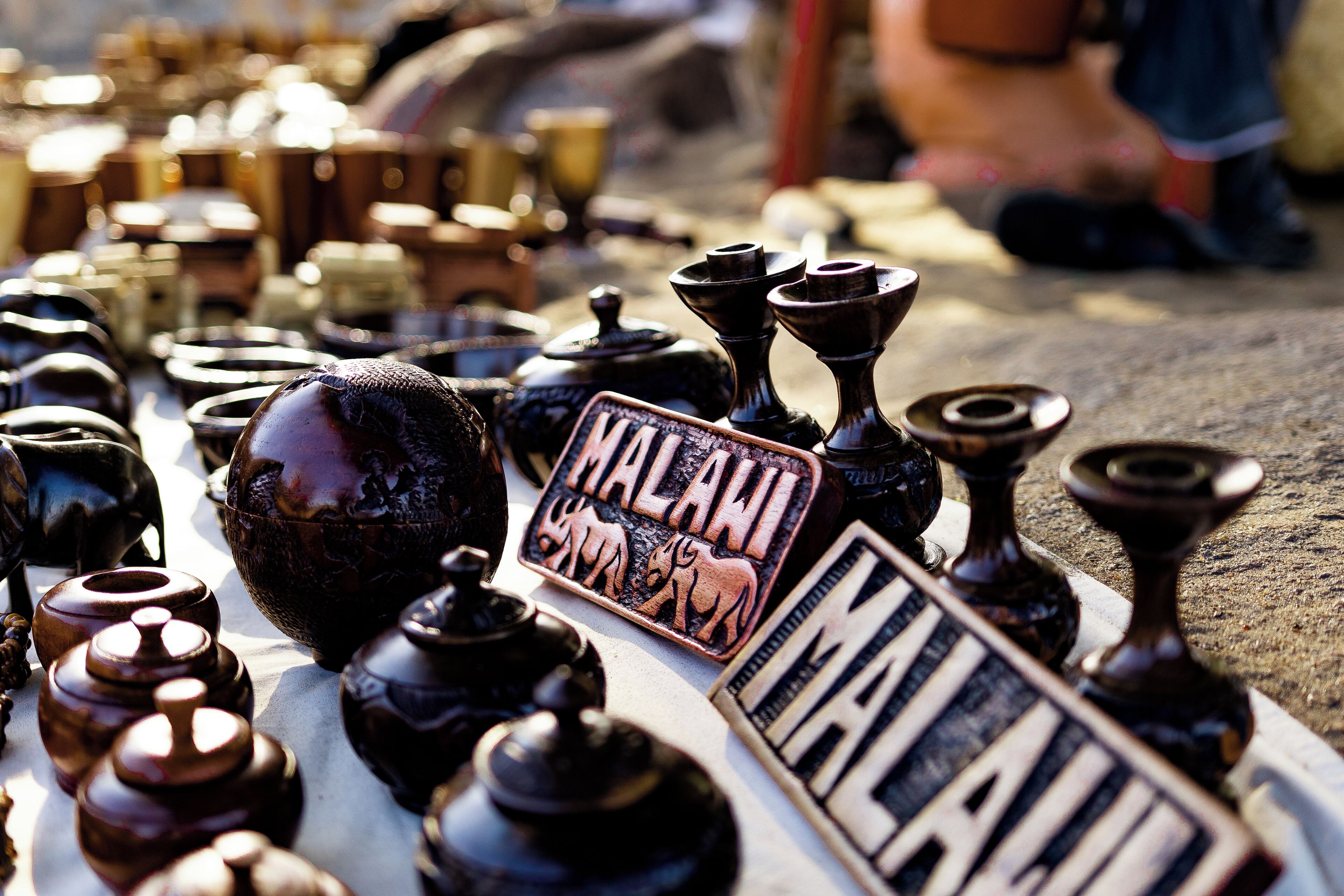 A variety of traditional Malawian pottery and utensils displayed on a table.