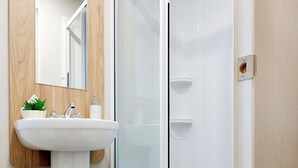 Ein Badezimmer mit Waschbecken, Spiegel und Holzvertäfelung.
