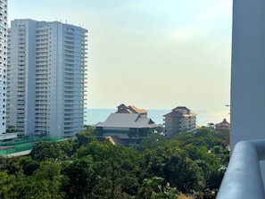 A high-rise building with a view of the sea and other buildings. - Sea View Studio With Large Balcony at View Talay 5D (Pattaya)