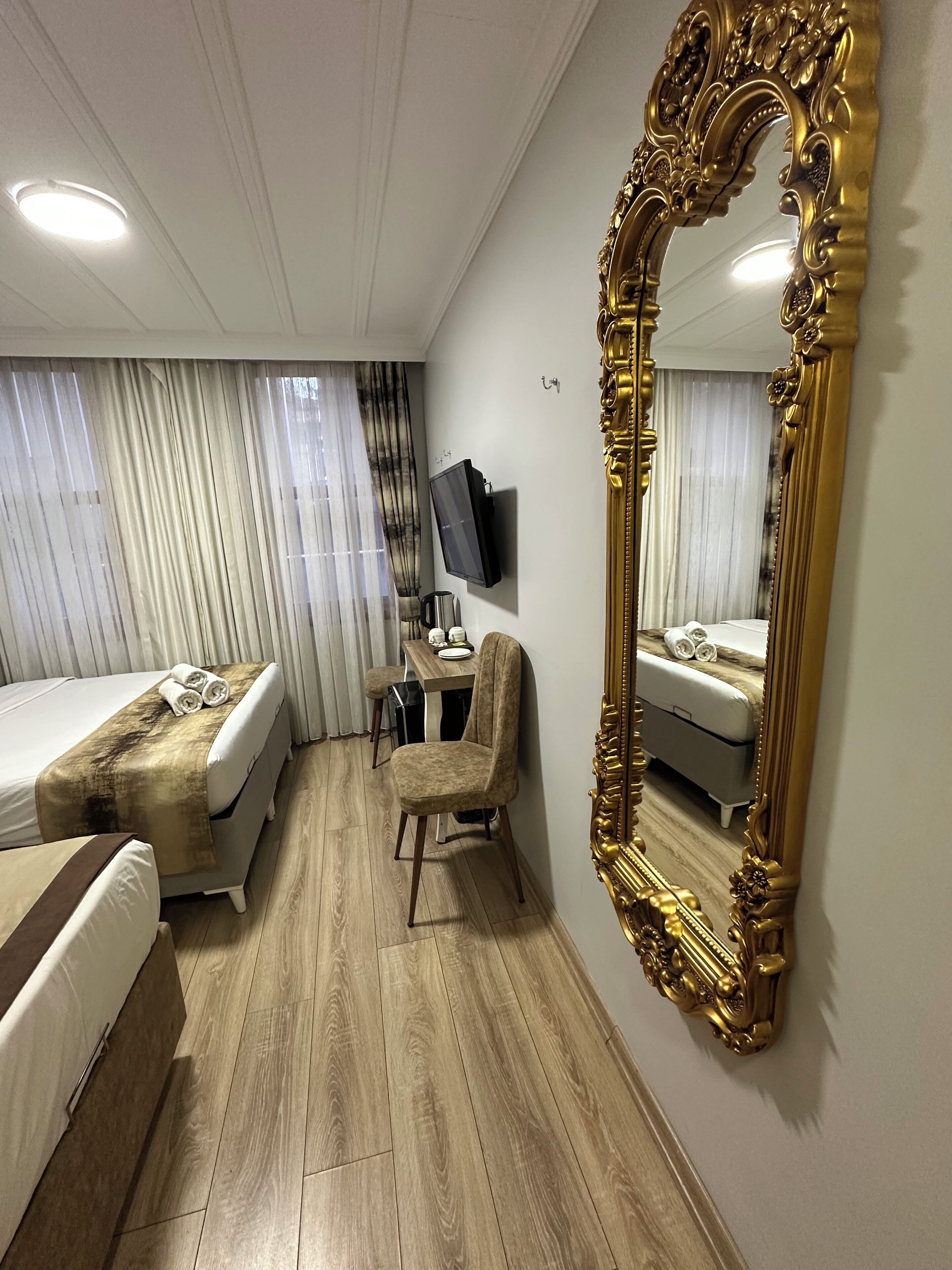 Deluxe Triple Room, Courtyard View | In-room safe, desk, soundproofing, iron/ironing board