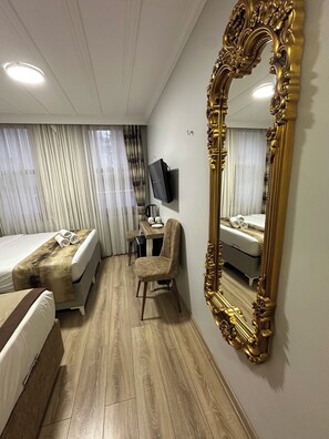 Deluxe Triple Room, Courtyard View | In-room safe, desk, soundproofing, iron/ironing board