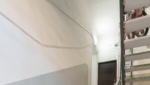 A staircase with a white handrail leading to a door at the top. - Designer suites on Mashtots avenue (Yerevan)