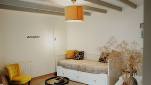 A modern living room with a sofa, a yellow armchair, a floor lamp, and a coffee table. - Cosy house in Volvic - Calm, nature & volcanoes (Volvic)