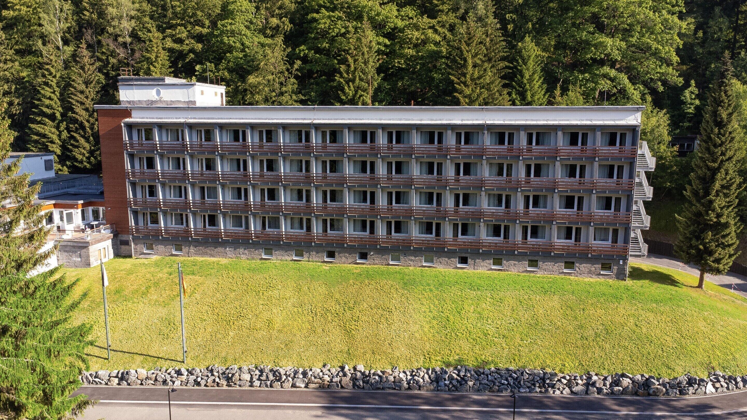 A modern multi-story hotel with a flat roof and a symmetrical facade.