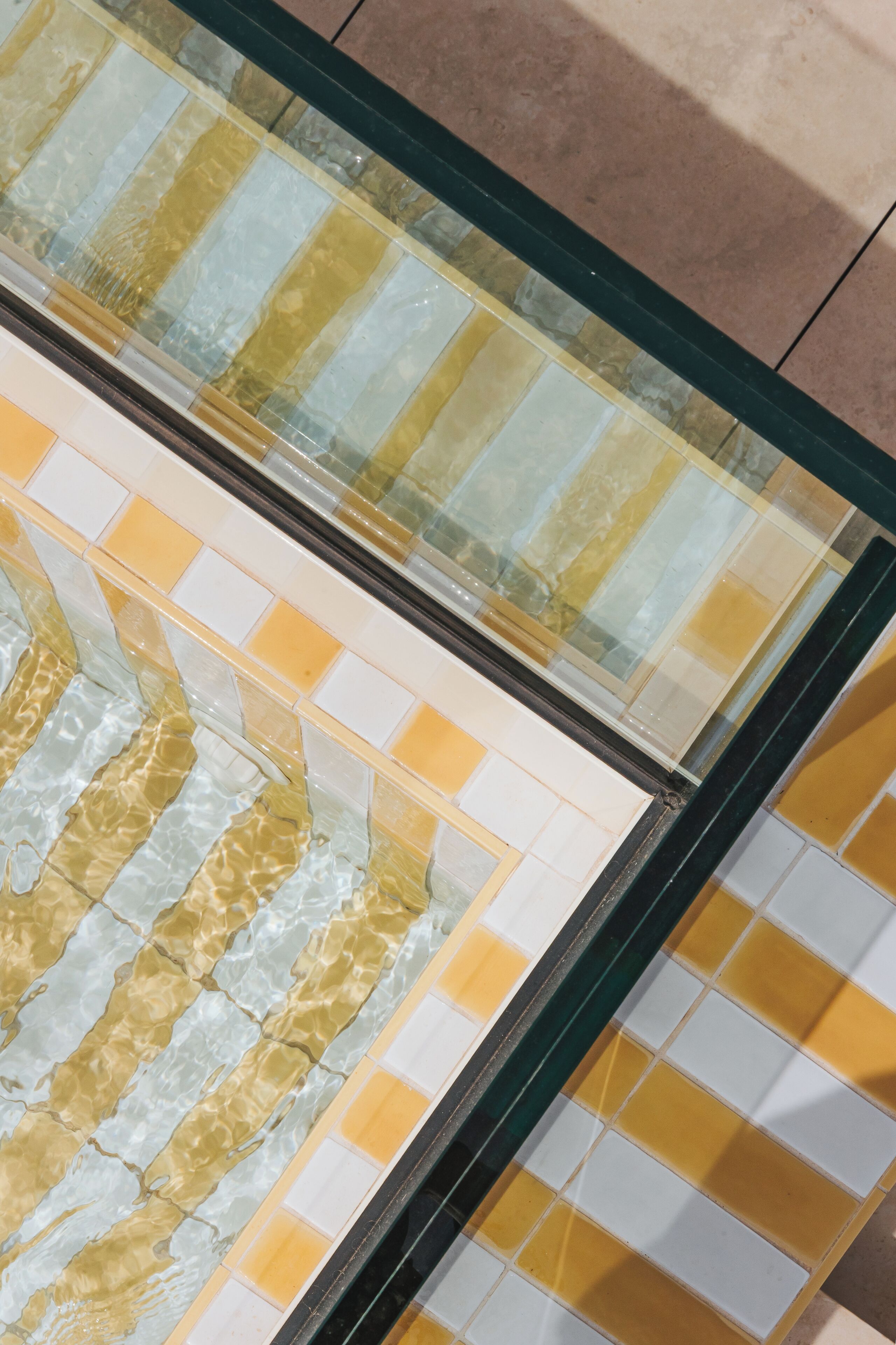 A tiled floor with a pattern of yellow and white tiles.