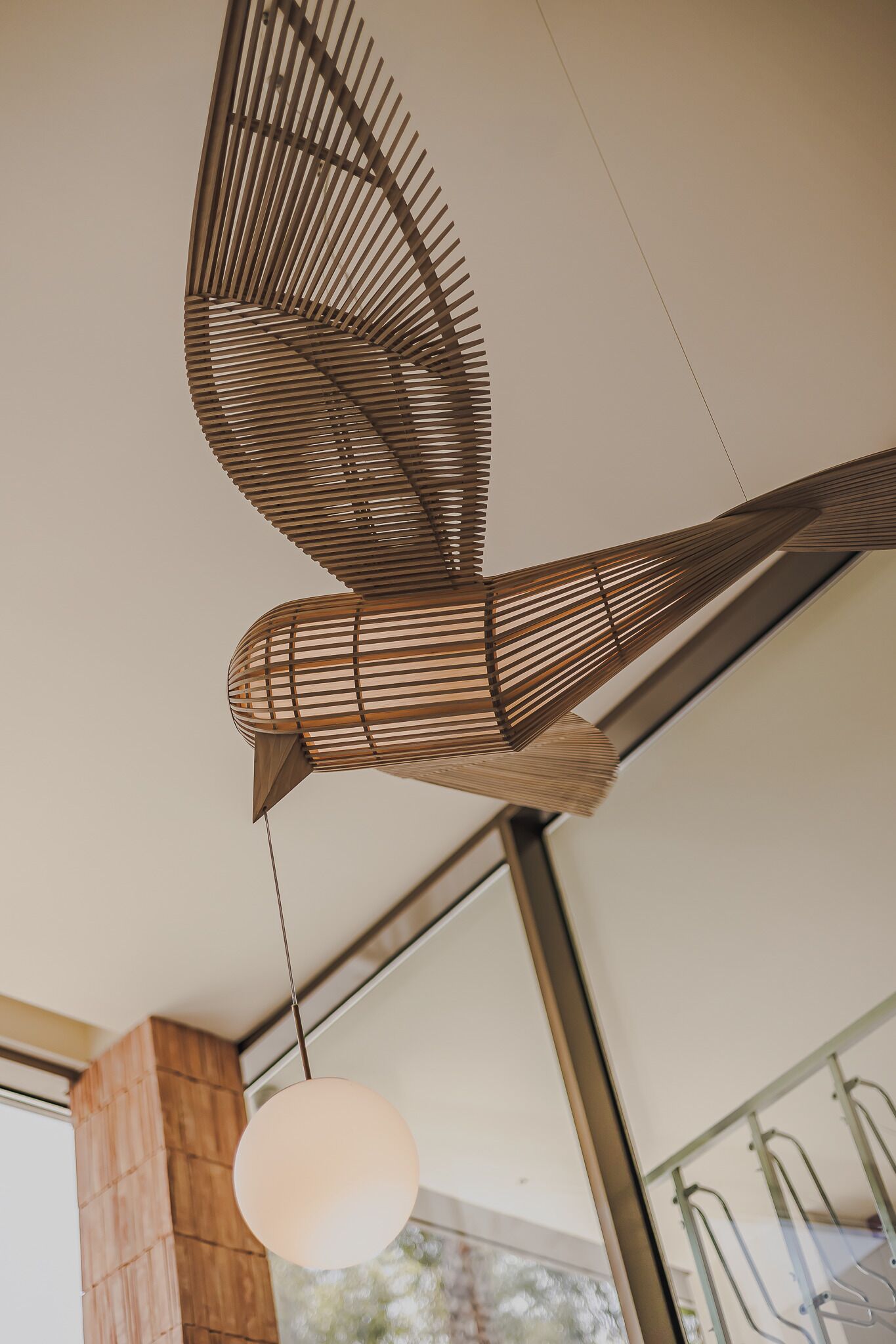 Et moderne interiør med et unikt loftsdesign, der inkluderer en fugleformet konstruktion.